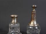 pair of antique cut glass bottles with silver tops