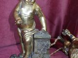 a statue of a boy on a box next to a dog