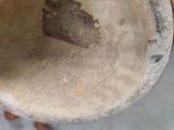 a person holding a banana in a bowl of water