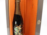 a bottle of champagne in a box on a white surface
