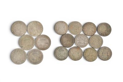 two pieces of old coins sitting on top of a white surface
