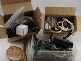 two boxes of assorted items sitting on a table