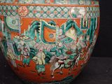 a large vase with a painting on it sitting on a table