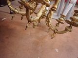 a gold colored chandelier that is sitting on the floor