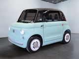 a small blue car that is sitting in a room