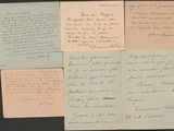 several handwritten letters are displayed on a black surface