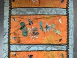 an orange and blue table runner with butterflies on it