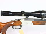 a close up of a rifle with a scope on a white background