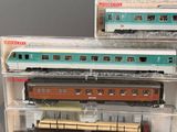 three model trains sitting on display in a display case