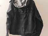 denim jacket hanging on a hanger on a wall in a room