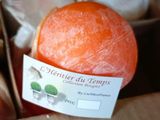 an orange in a box with a label on it