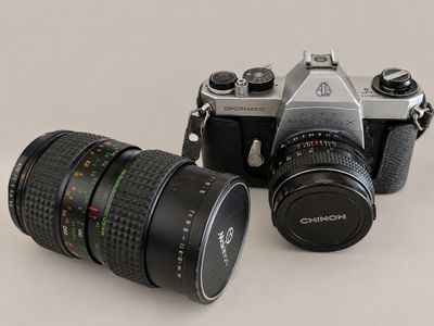 two cameras sitting next to each other on a table