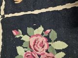 a close up of a rug with a bunch of flowers on it