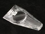 a clear glass object on a black surface