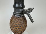 a black and brown vase with a handle on a stand