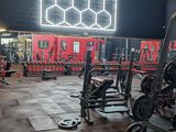 a gym with a lot of equipment in the room