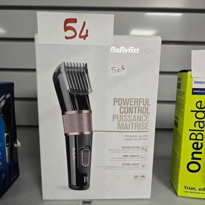 une boîte sur laquelle est représentée une tondeuse à cheveux