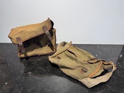 pair of vintage canvas messenger bags with leather handles