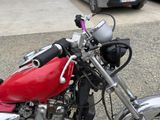 a red motorcycle parked on the side of the road