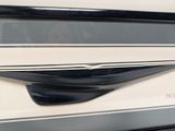 a close up of a black and white car door handle