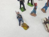 many figurines of men in uniforms on a white surface