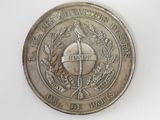 an old coin with a cross on it on a white surface