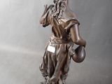 bronze statue of a woman holding a water jug