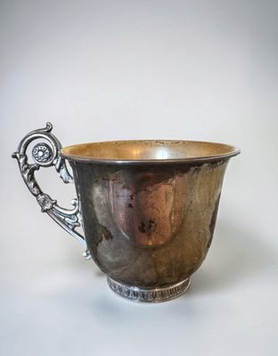 a silver cup that is sitting on a table