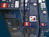three boxes of legos that are stacked on top of each other