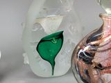three glass vases sitting next to each other on a table