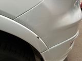 a close up of a car ' s front bumper with a hole in it
