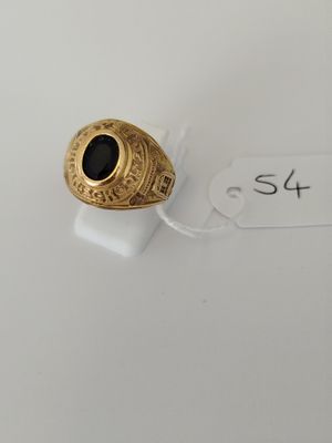 a close up of a gold ring with a black stone on it