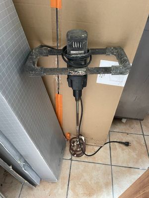 une photo d'un chauffe-eau auquel est raccordé un tuyau