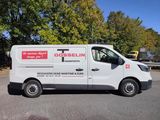 a white van that is parked on the side of the road