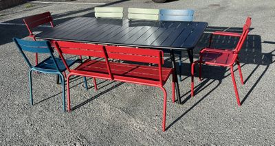 tables and chairs in a parking lot with a truck in the background