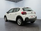 the rear of a white citrole parked in a garage