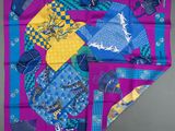 a close up of a purple and blue scarf with a design on it