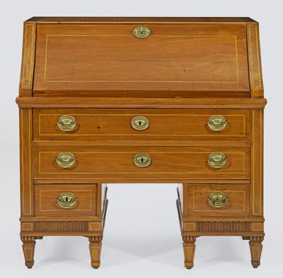 a small wooden desk with drawers and brass pulls