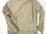the back of a beige jacket on a white background