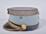 a hat with a chain around it on a white surface
