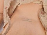 a doll that has a tattoo on it ' s back