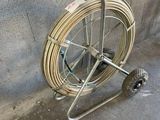 a cart with a hose attached to it on the sidewalk