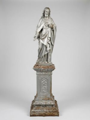 a statue of a woman holding a child on a pedestal