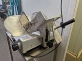 an image of a commercial meat slicer in a kitchen