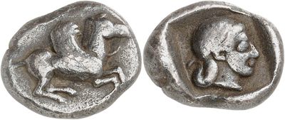 a close up of a coin with a horse and a man on it