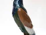 a figurine of a bird sitting on top of a rock