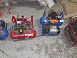 several air compressors are lined up on the floor in a garage