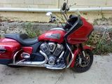 a red motorcycle that is parked in front of a building