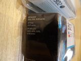 a cell phone sitting on top of a table next to a package