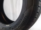 tire on a white surface with a white curtain in the background